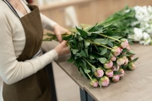 Florist working with flowers making a composition